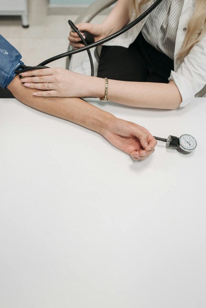 person getting blood pressure monitored - Preventative Health Screenings
