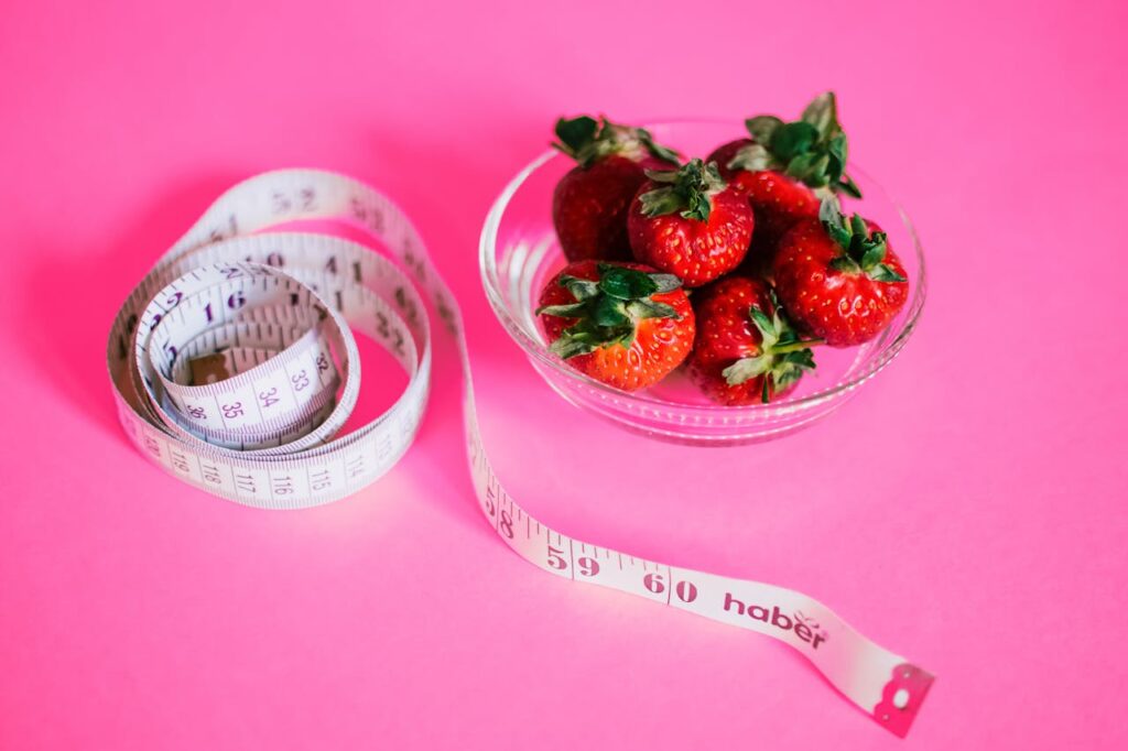 measuring tape and strawberries - Personalized Weight Loss