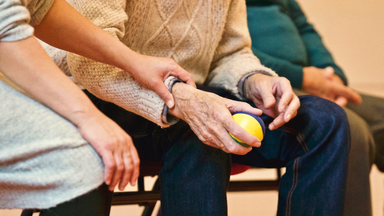 one person holding another person's arm - Social Connection Outperforms Medication