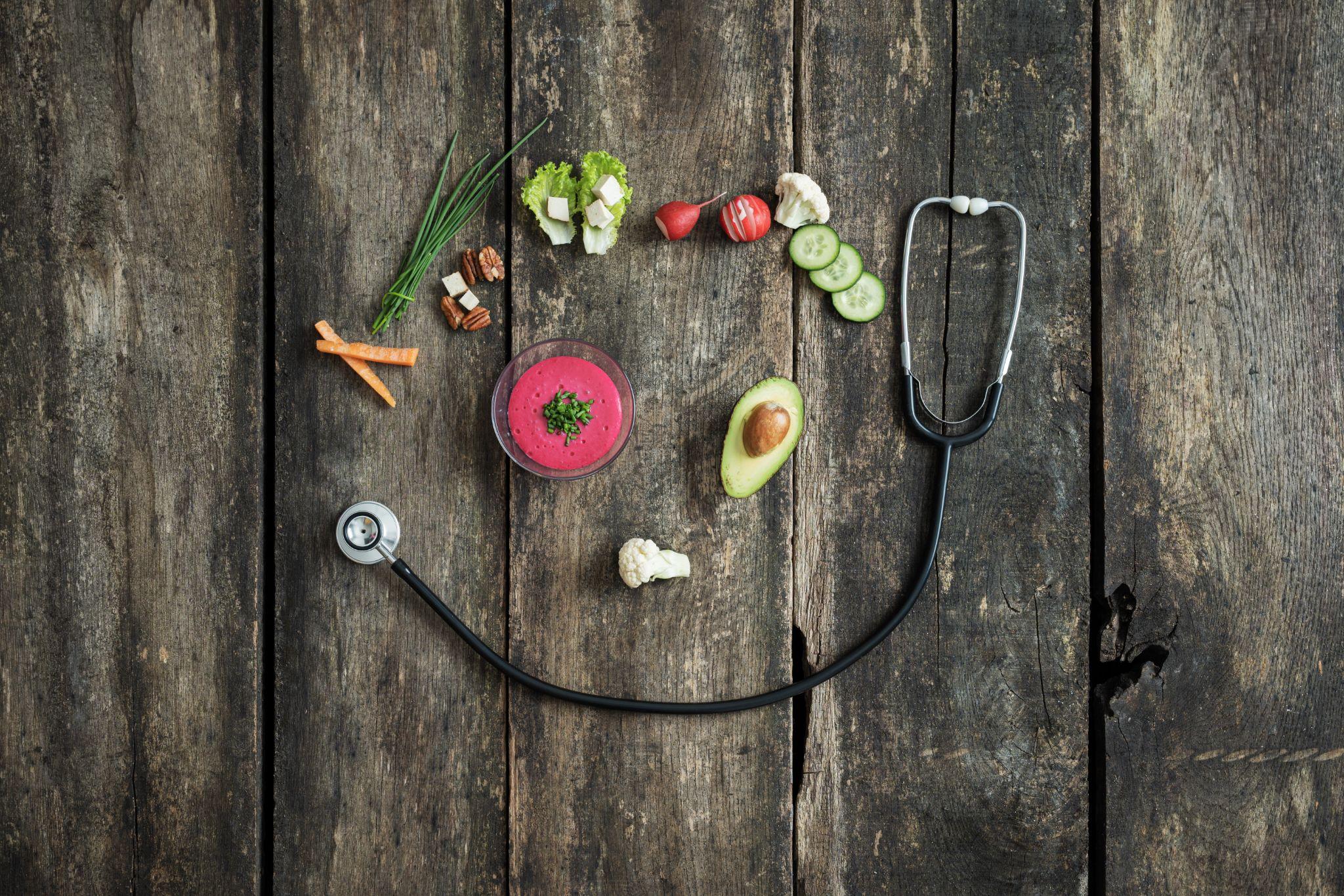 stethoscope and vegetables forming a smiling face, representing wellness without barriers from Direct Primary Care in Humble TX
