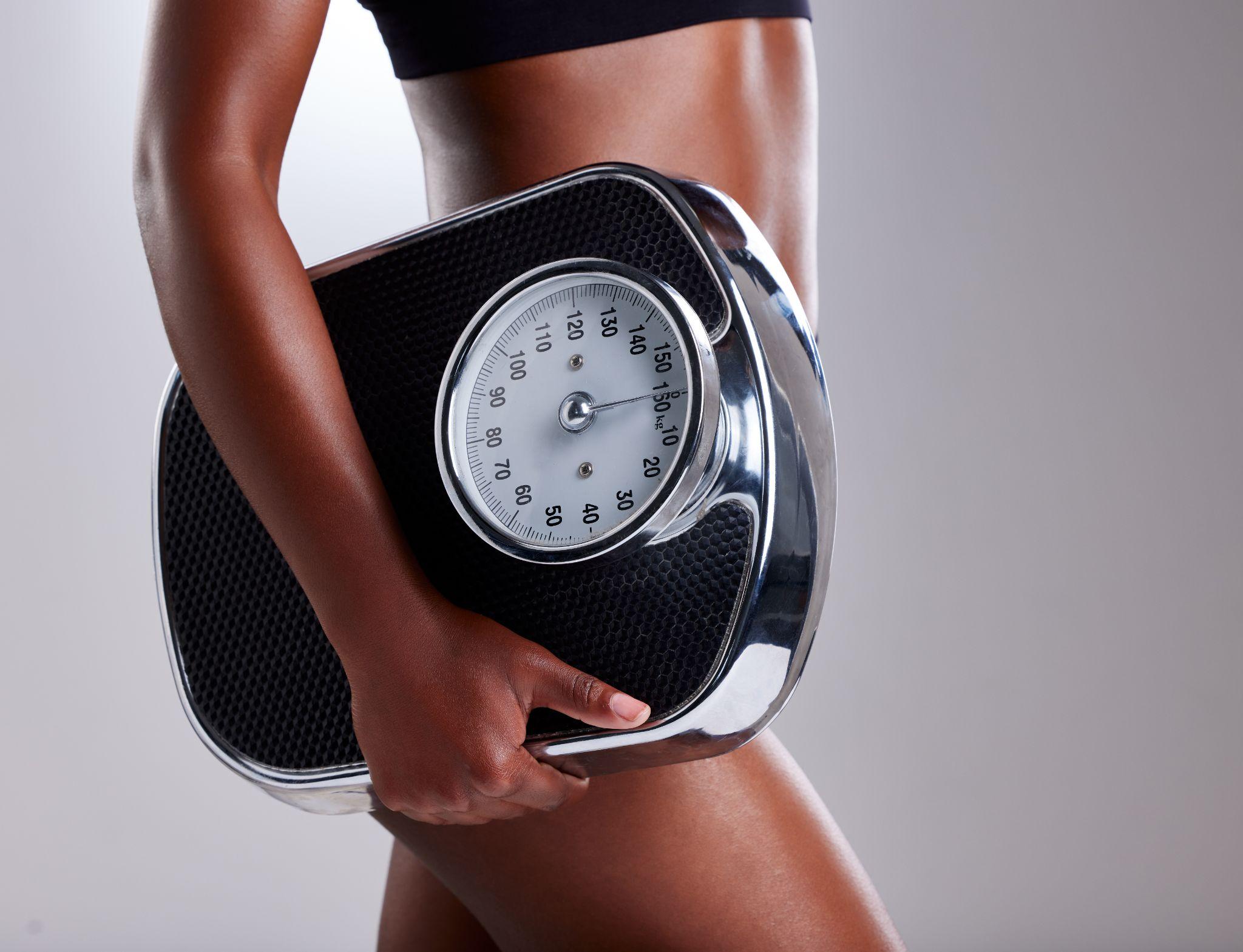 woman holding weighing scale
