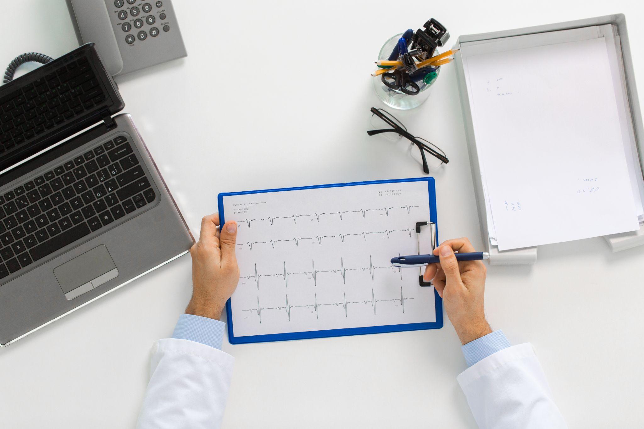 doctor looking at lab test results of patient