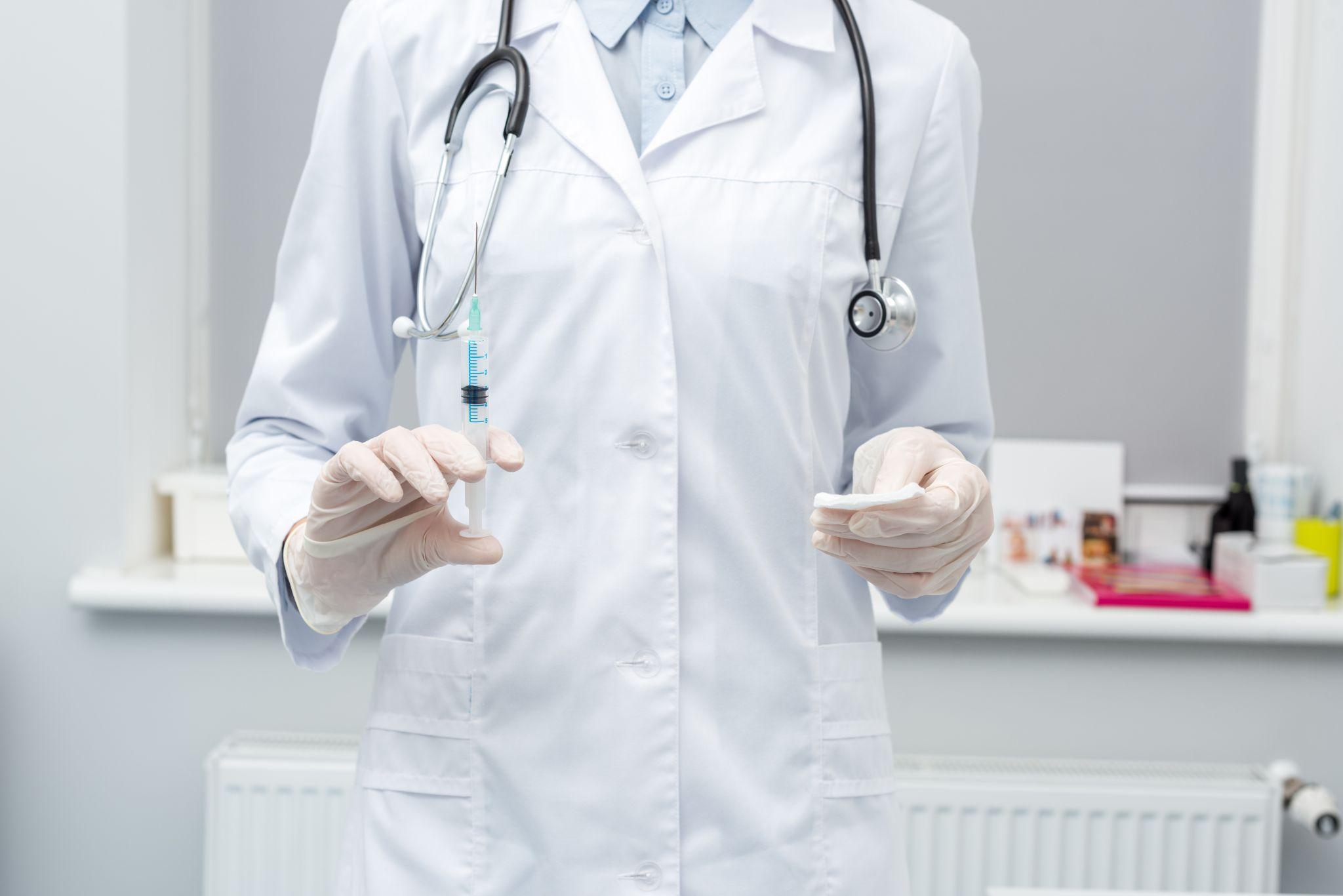 doctor holding syringe