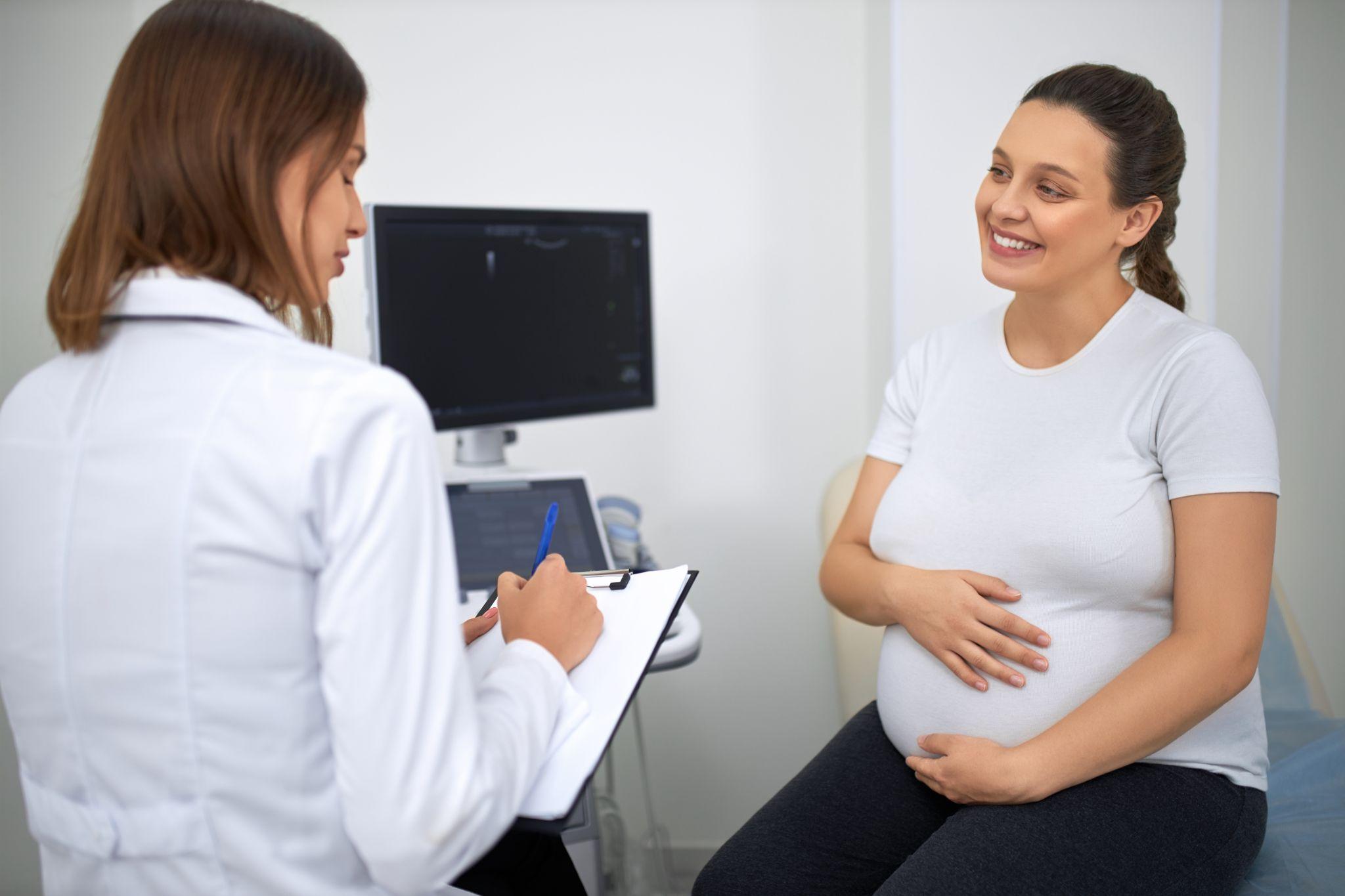 Doctor providing prenatal and postpartum care during women’s health services.