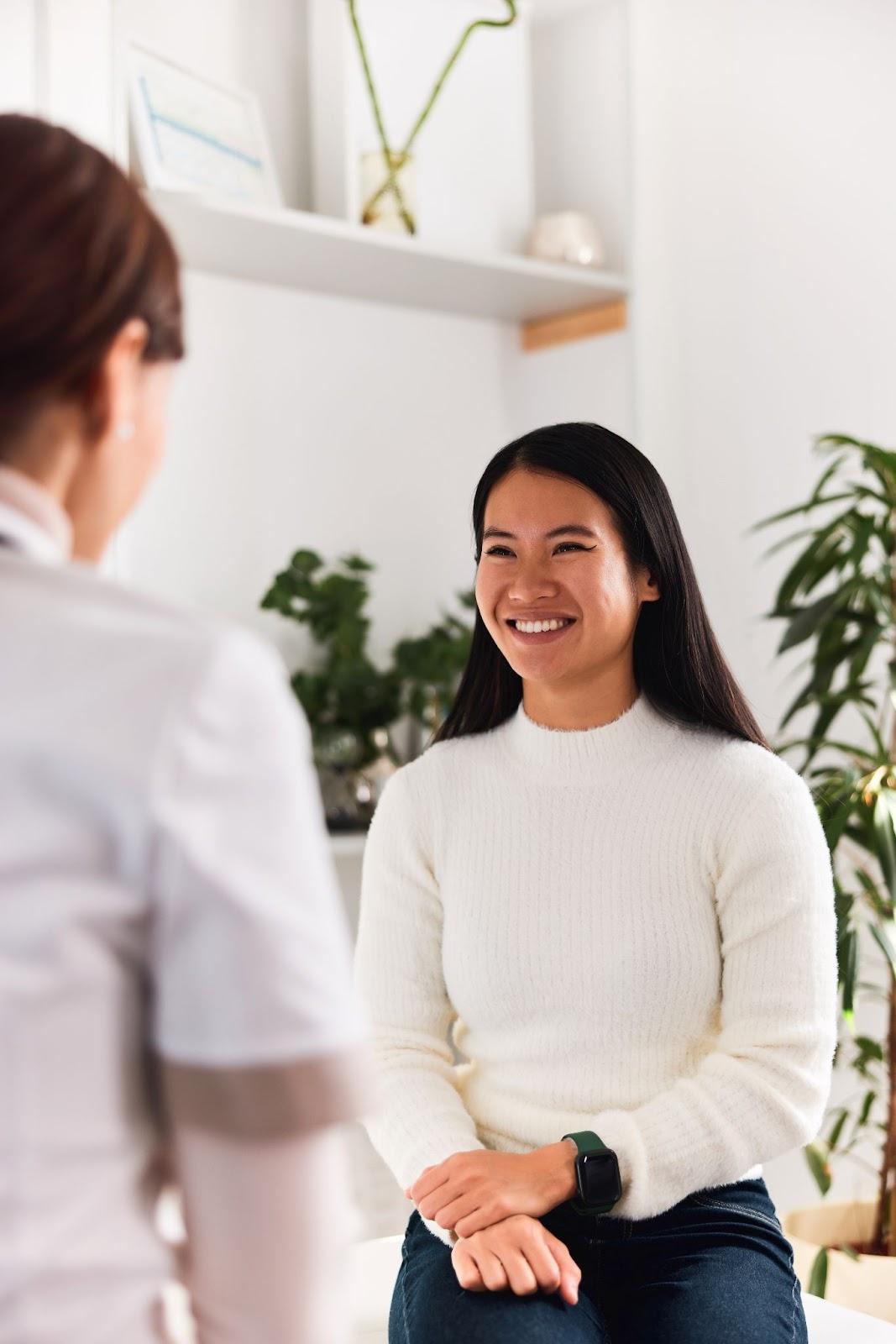 Smiling patient talking with doctor after wellness exam in Humble TX