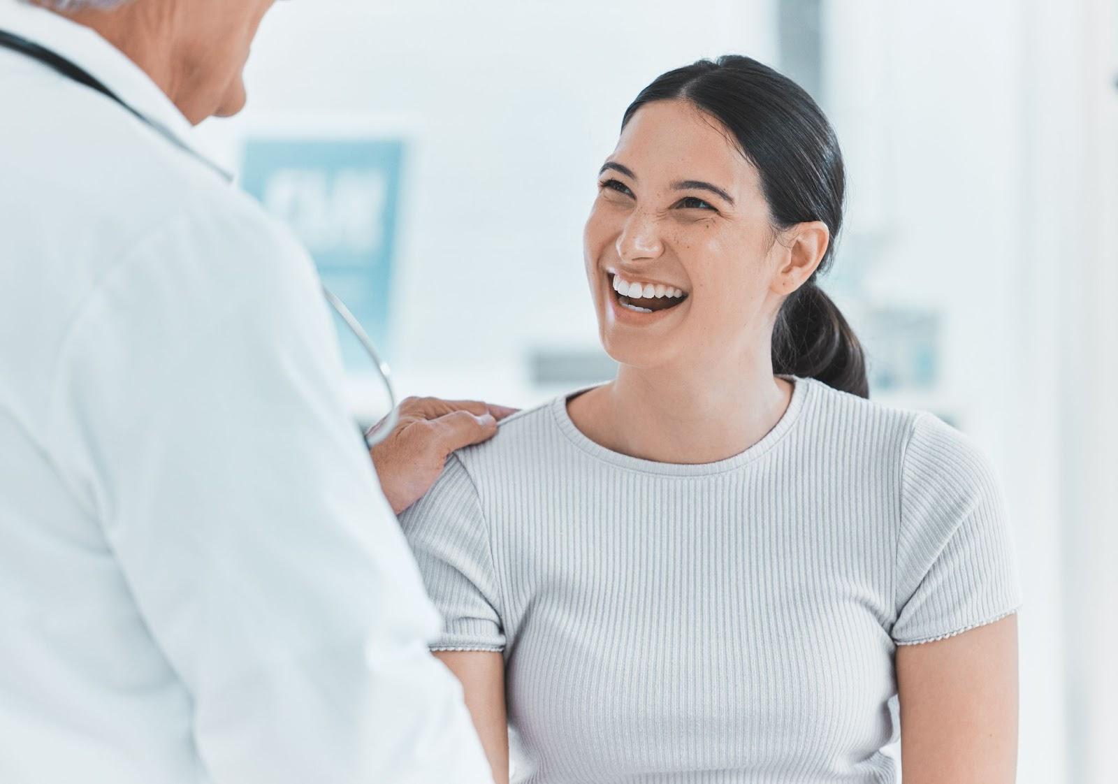 Doctor with patient smiling after appointment