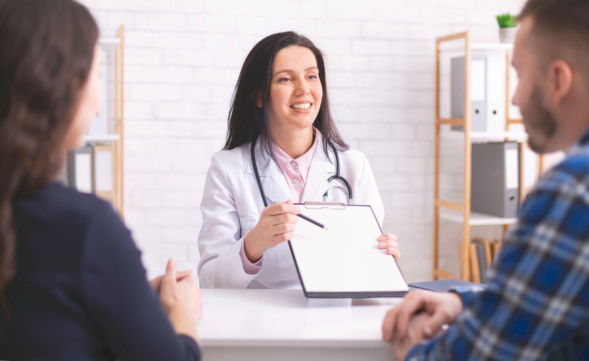 Doctor reviewing a patient’s wellness schedule during a preventative health visit.