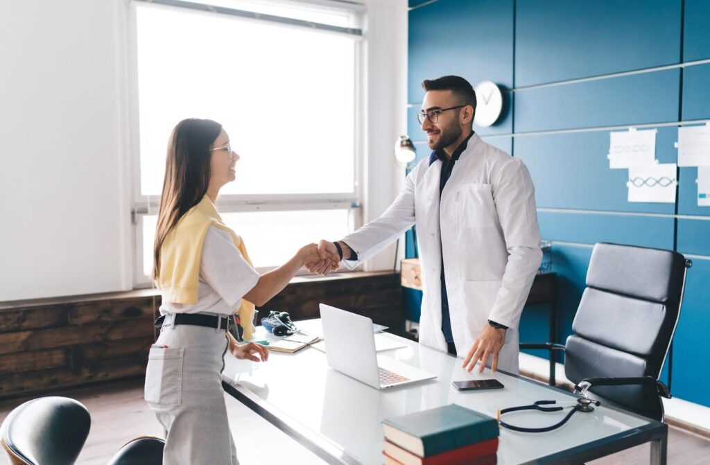 DPC physician near Fall Creek TX talking with a patient during a relaxed clinic visit.