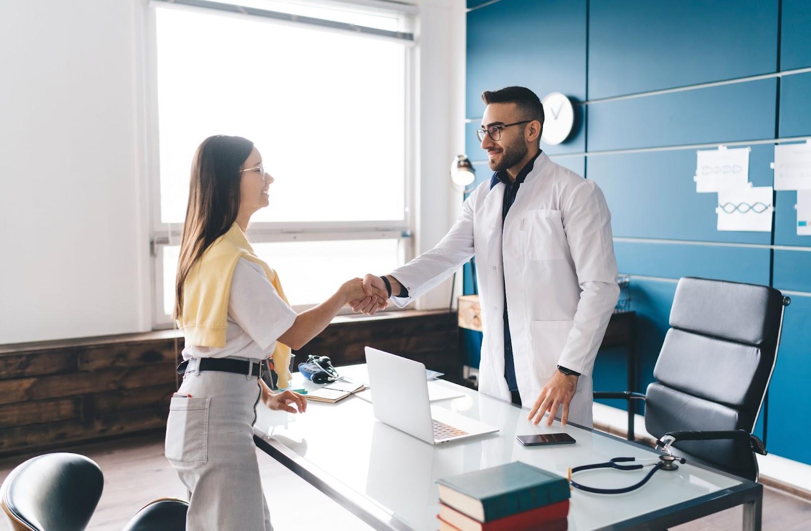 DPC physician near Fall Creek TX talking with a patient during a relaxed clinic visit.