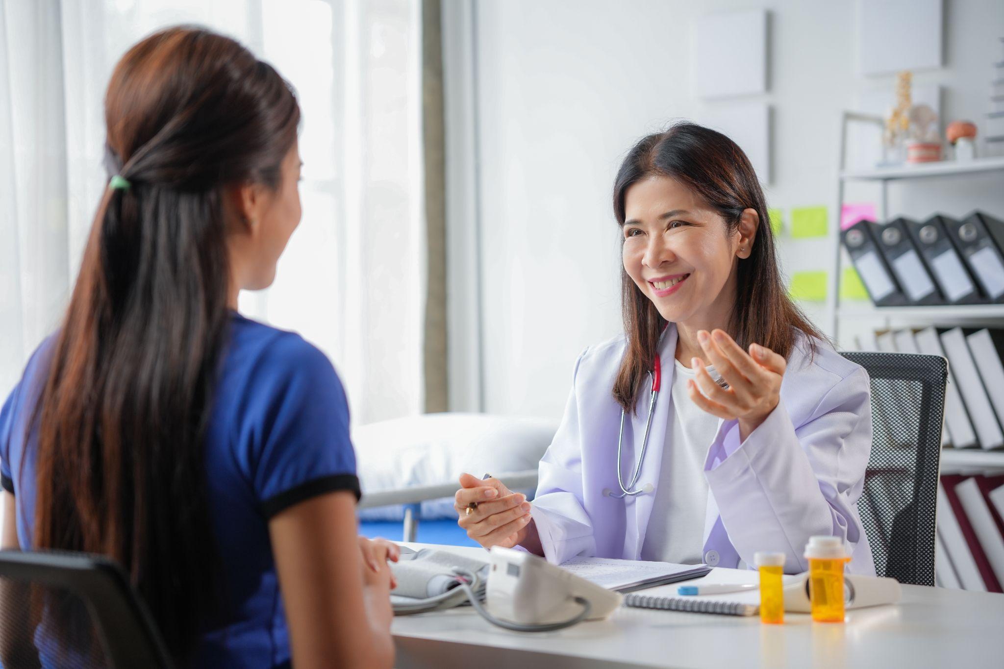 Doctor talking with a patient during a checkup, representing affordable primary care in Humble TX.