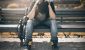 stressed man sitting on park bench - hidden costs of chronic stress