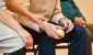 one person holding another person's arm - Social Connection Outperforms Medication