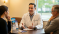 A doctor explaining to his patients why they should choose direct primary care, reflecting the benefits of accessible, supportive, and patient-centered healthcare.